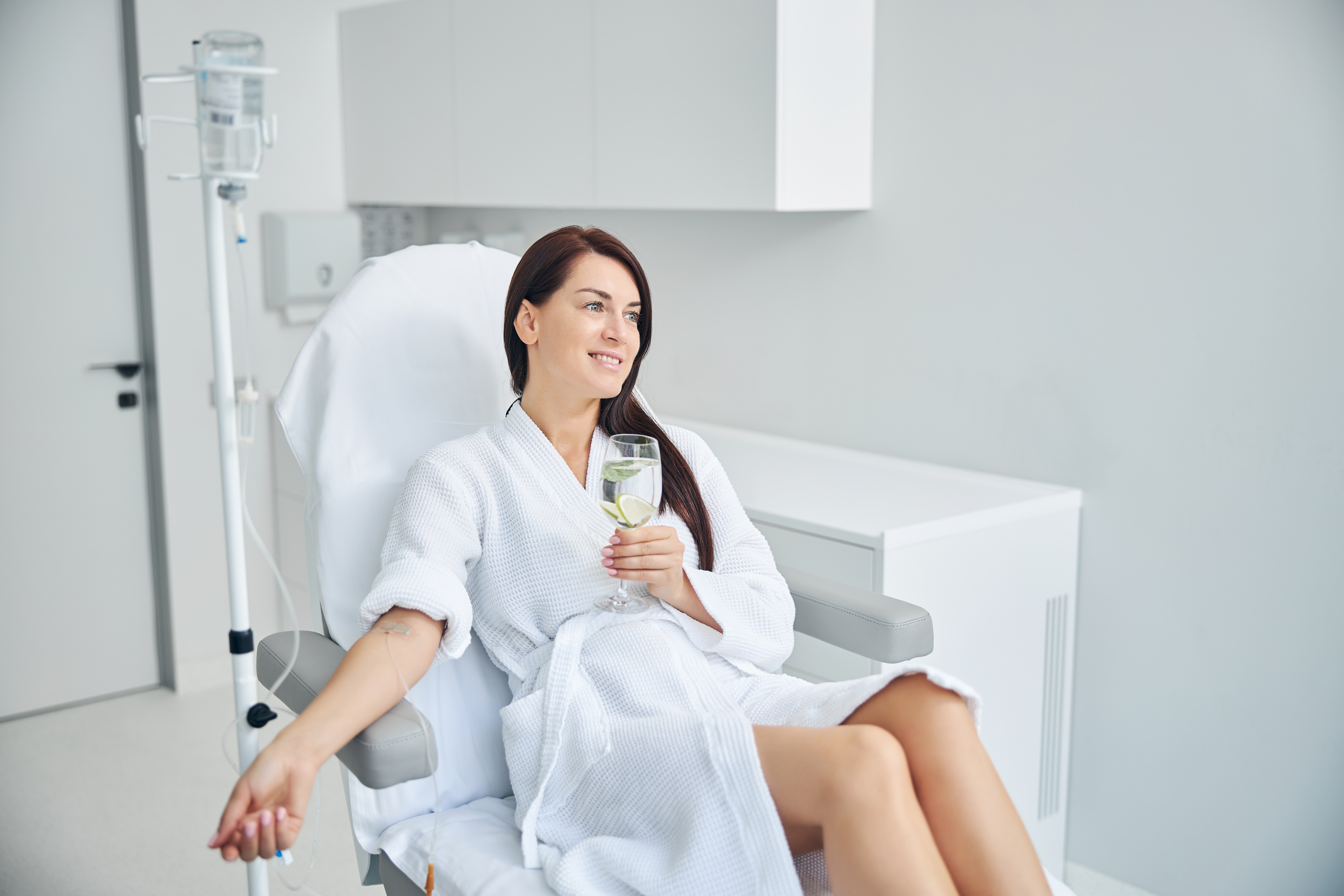 Beautiful lady with loose long dark hair gazing into the distance during a medical procedure